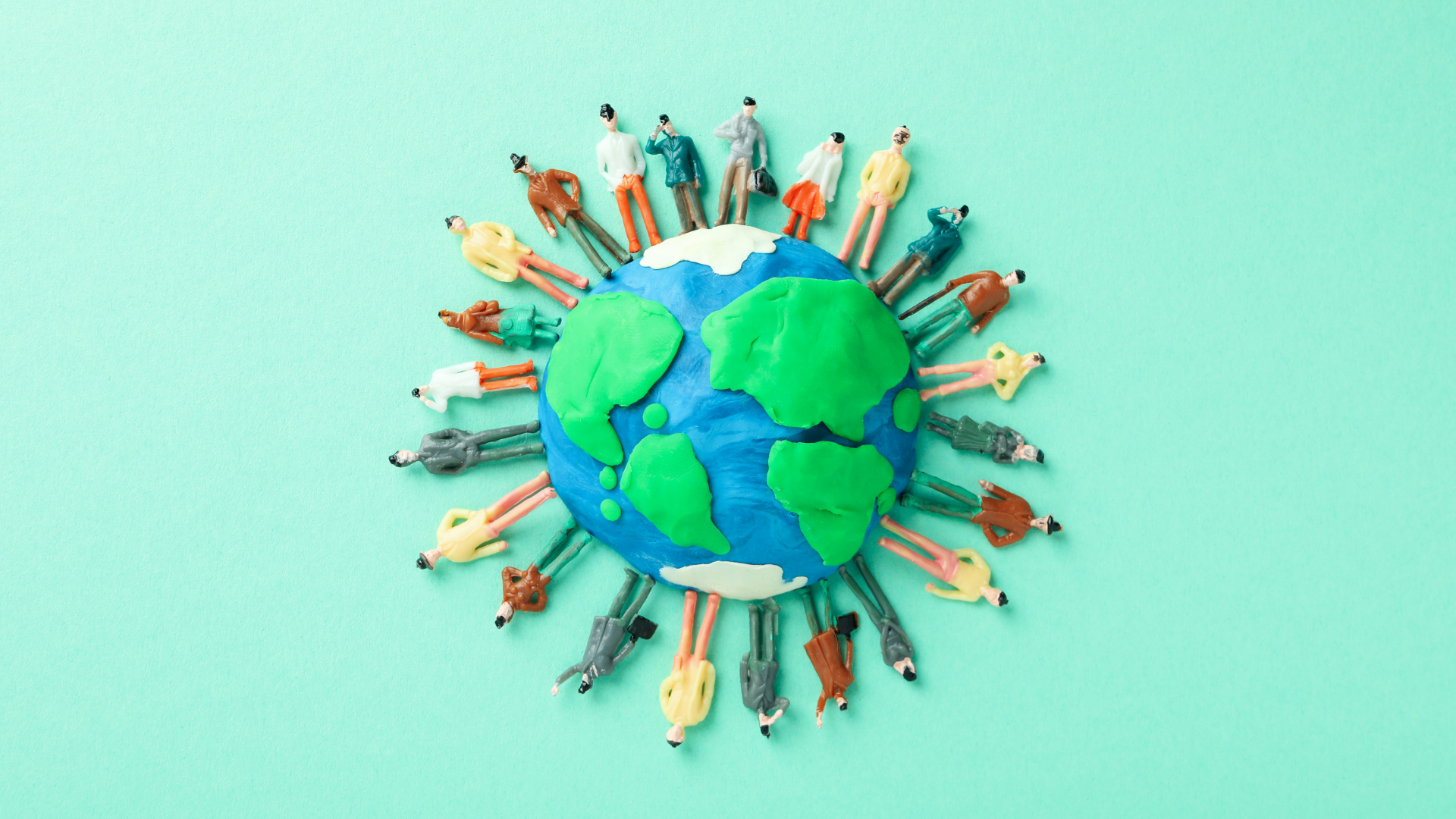 Globo terrestre con persone riunite intorno per la giornata internazionale del volontariato.